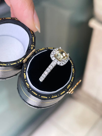 A champagne diamond engagement ring with white round brilliant cut diamonds set in a platinum band.