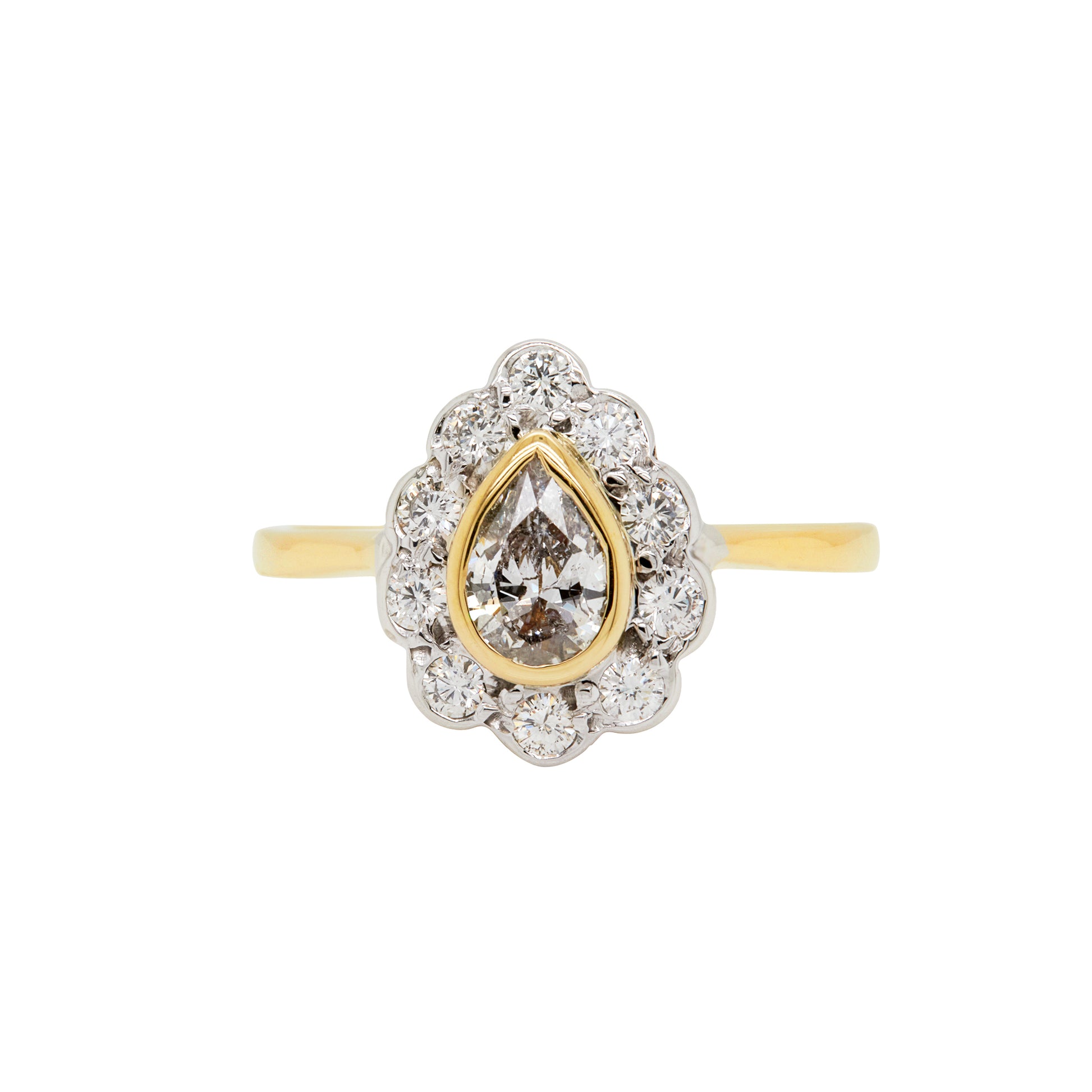 An 18 carat white and yellow gold pear shape diamond coronet cluster engagement ring with a central diamond surrounded by a halo of round brilliant cut diamonds.