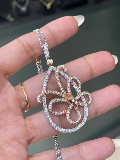An 18 carat white and rose gold diamond butterfly pendant with a chain.