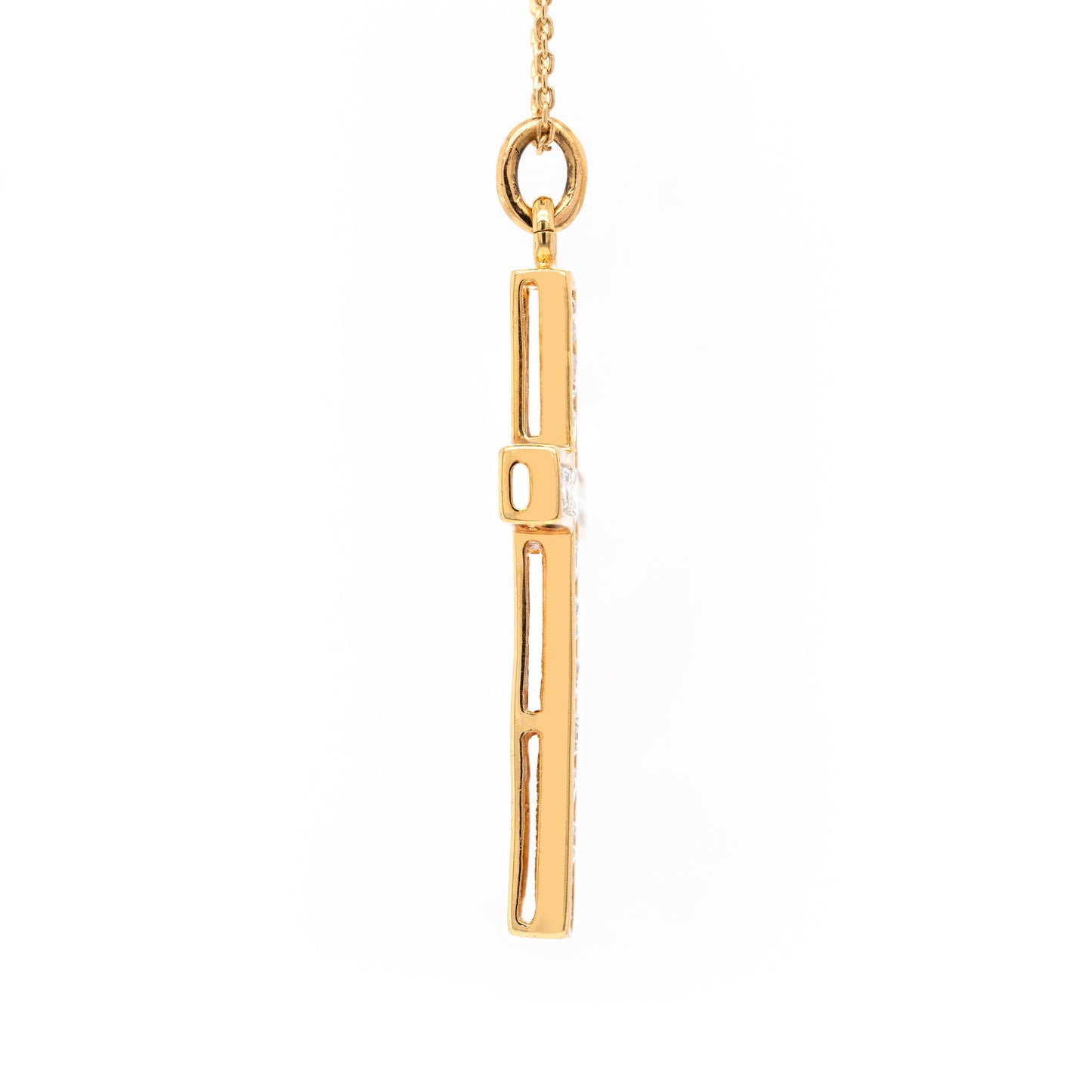 An 18 carat yellow gold diamond cross pendant with multiple round brilliant cut diamonds set within it.