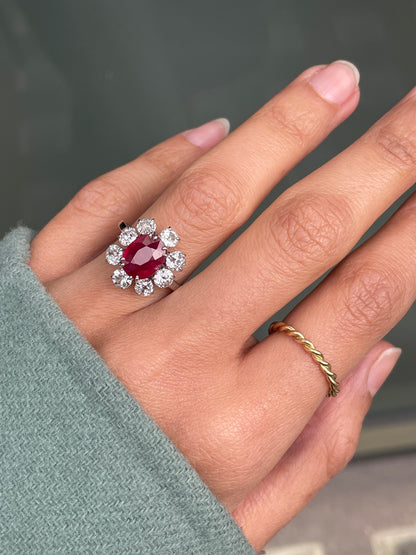 An 18ct white gold ruby and old cut diamond cluster engagement ring with French hallmarks on hand