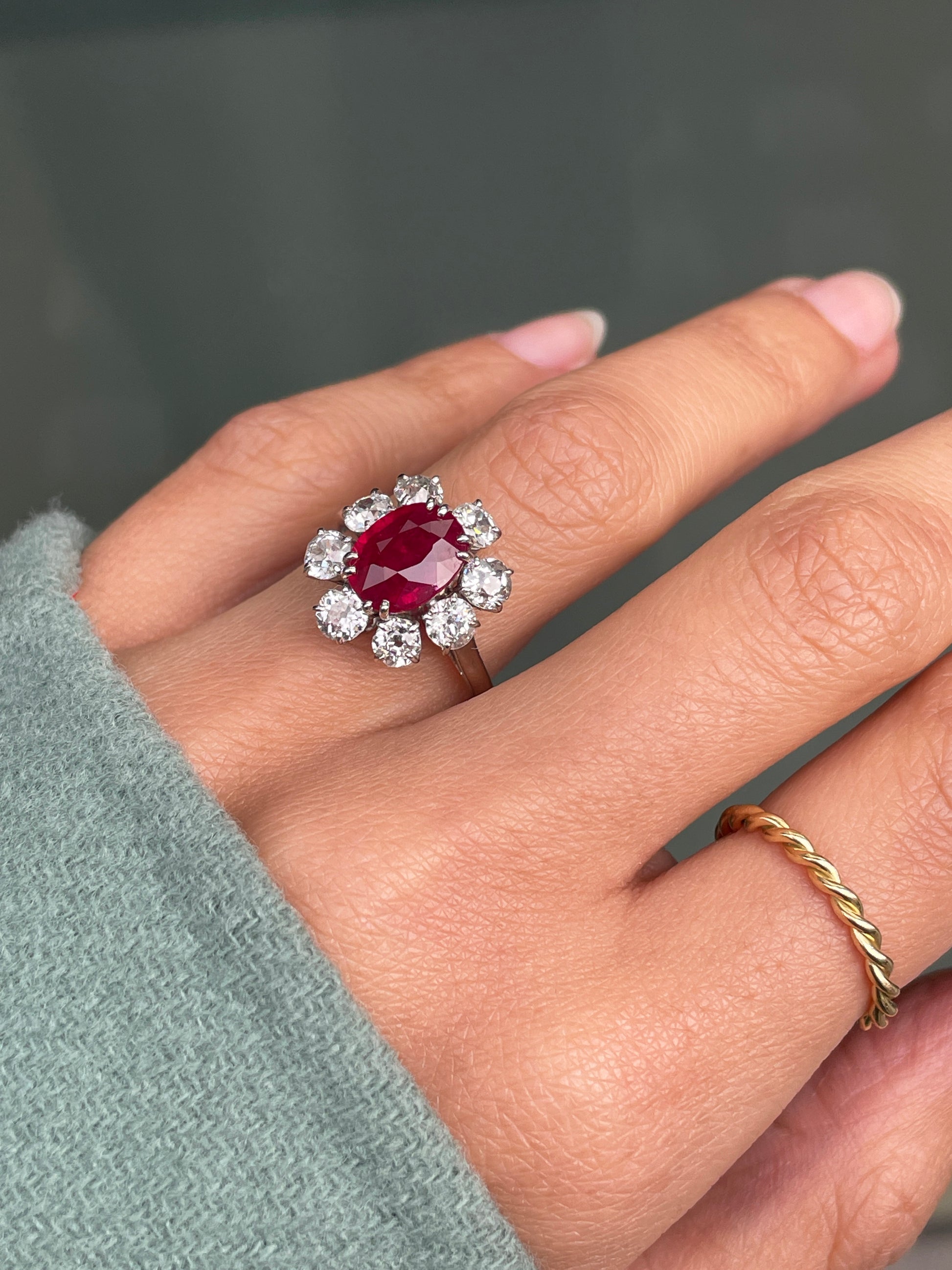 An 18ct white gold ruby and old cut diamond cluster engagement ring with French hallmarks on hand