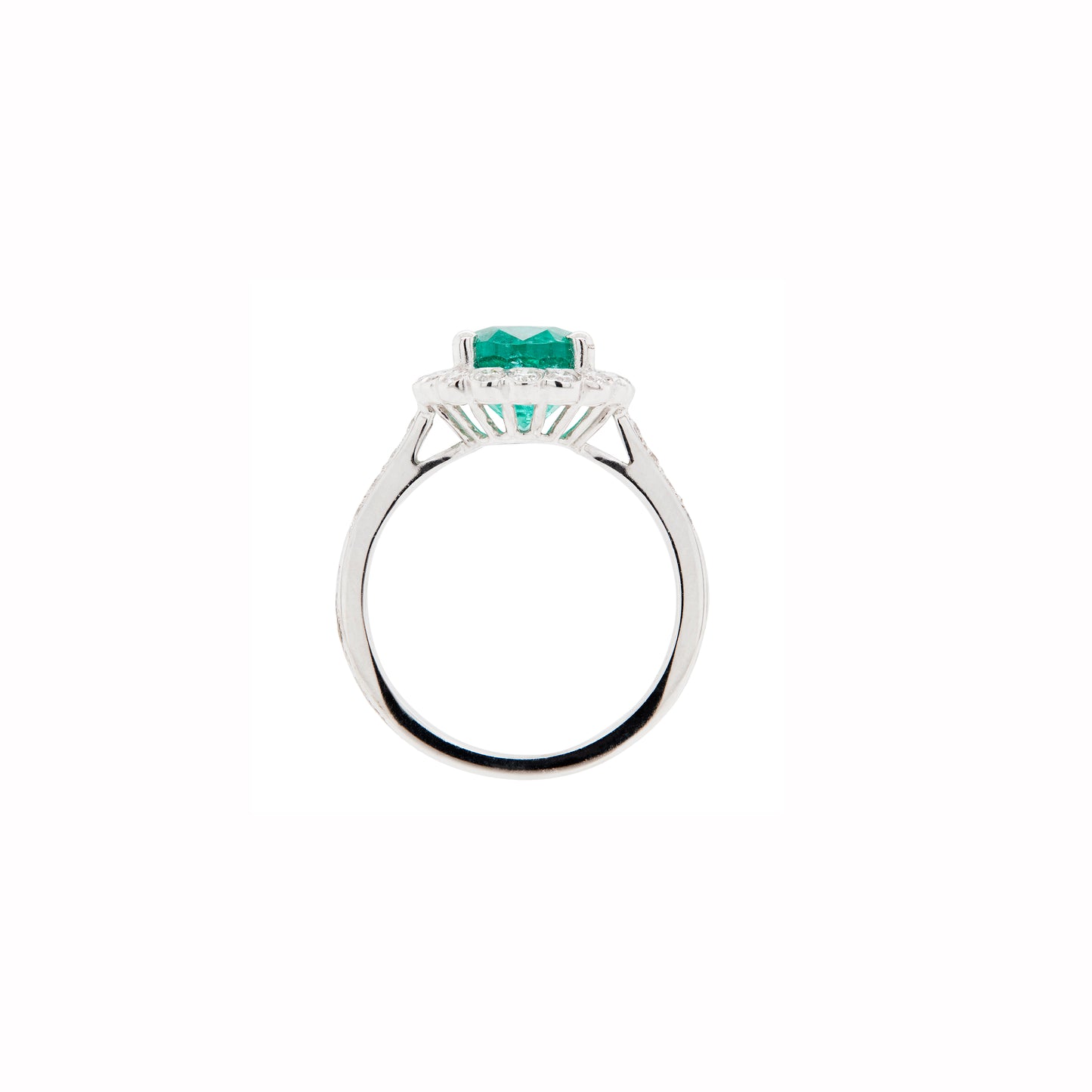 white gold ring with a green gemstone on a white background
