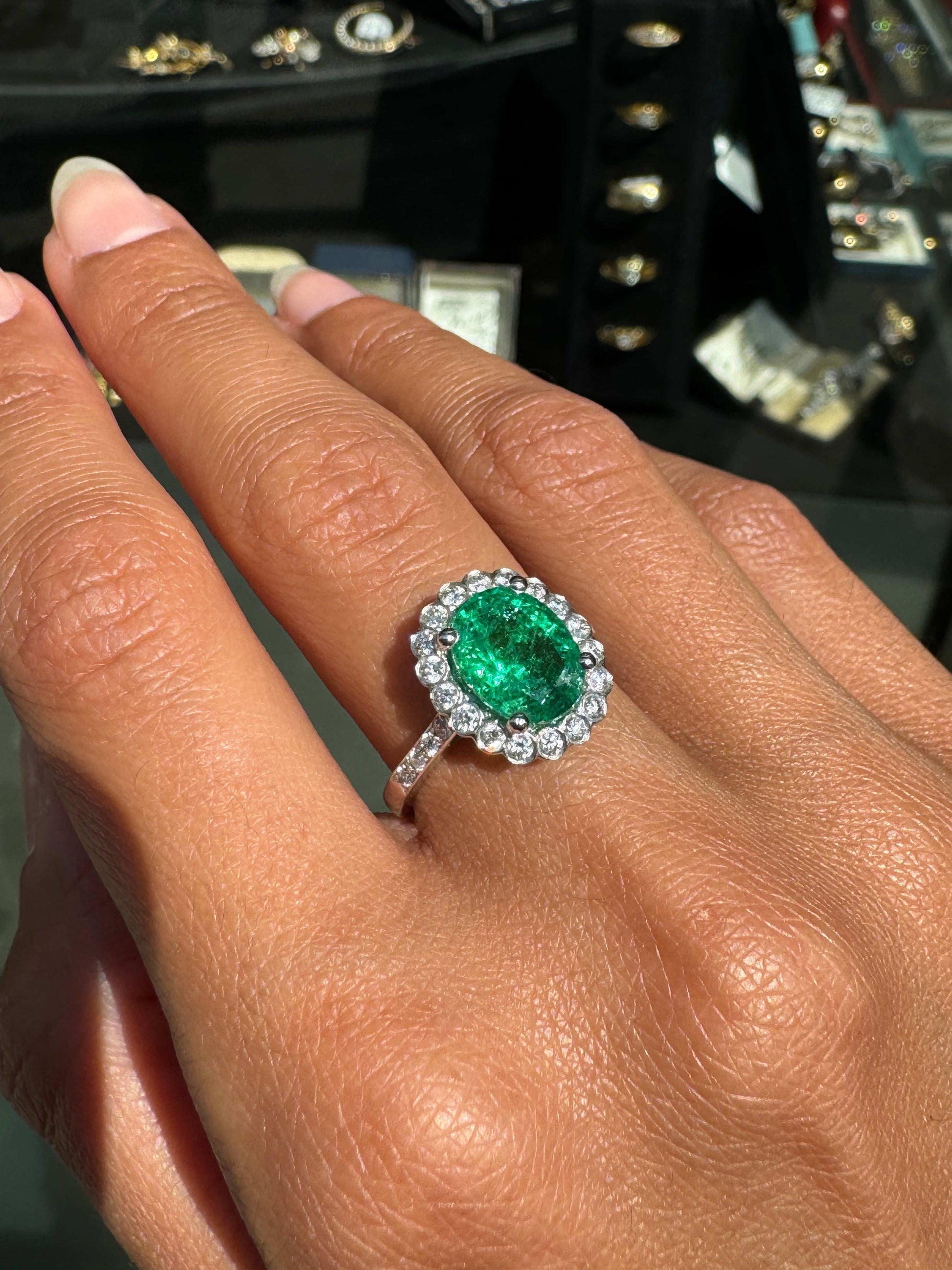 2.39ct Oval Emerald and Diamond Halo 18 Carat White Gold Cluster Engagement Ring on hand