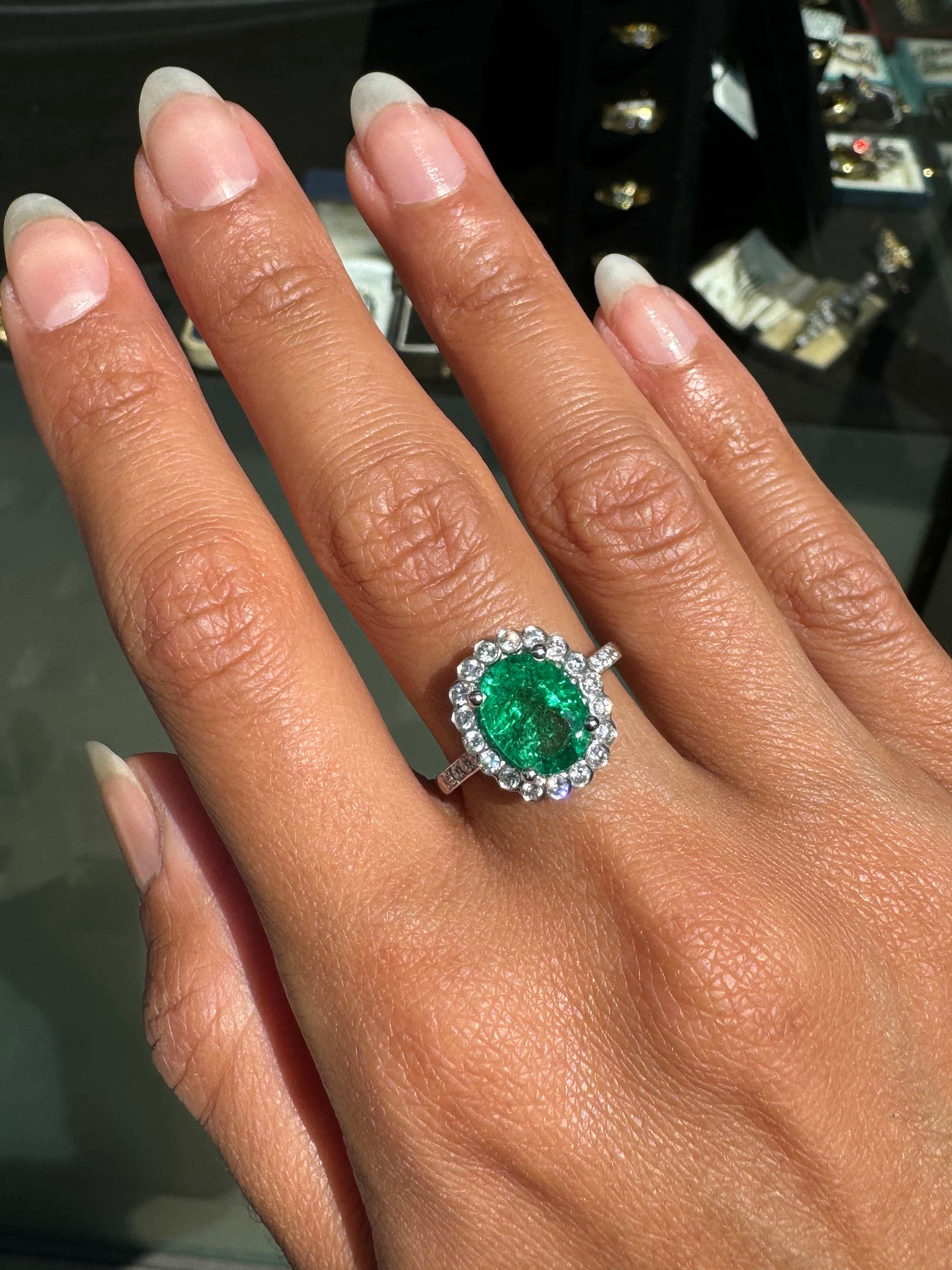 2.39ct Oval Emerald and Diamond Halo 18 Carat White Gold Cluster Engagement Ring on hand