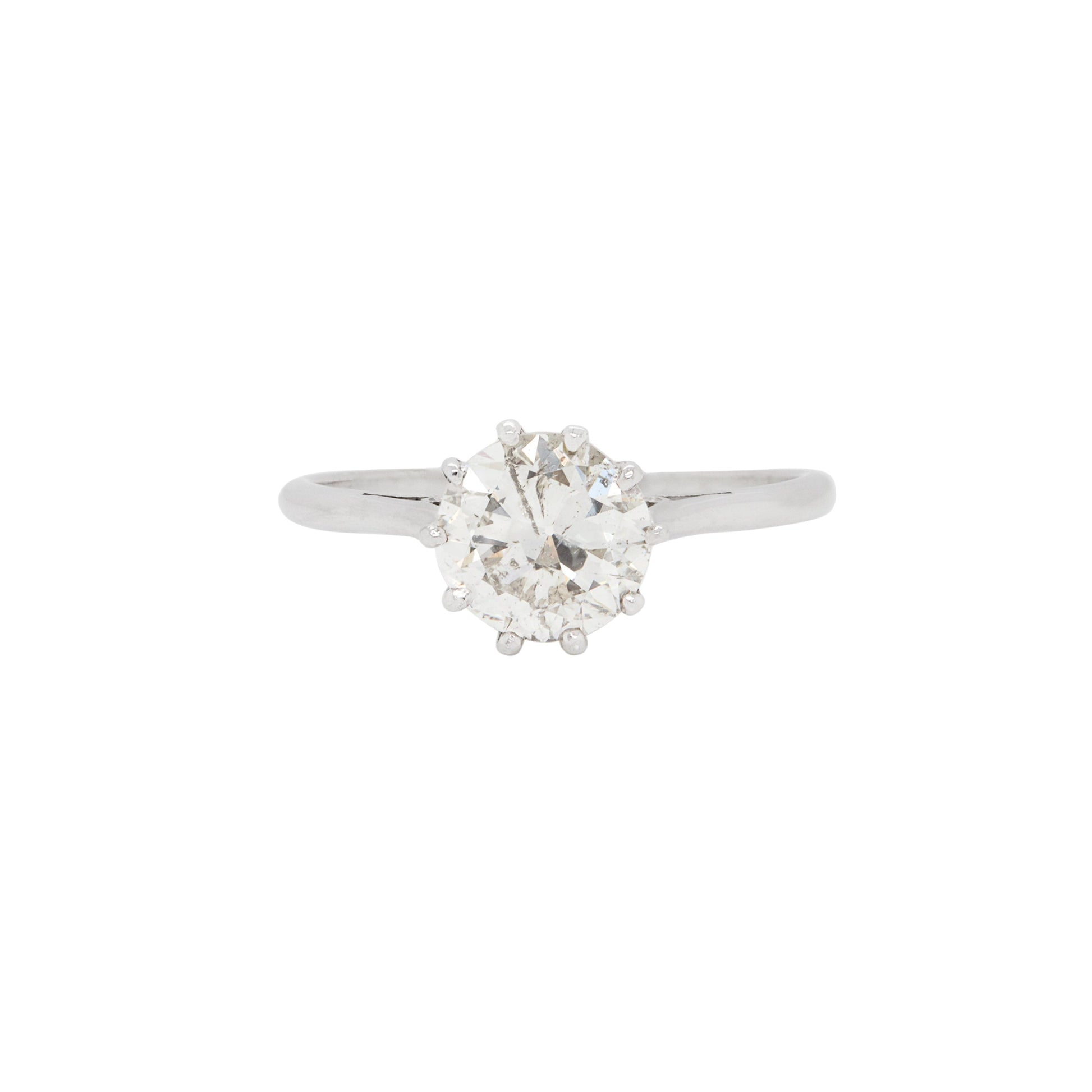 A vintage solitaire engagement ring featuring a 1.65ct old European cut diamond set in an eight claw, open back setting with a slender 18 carat white gold band.