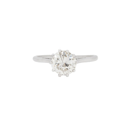 A vintage solitaire engagement ring featuring a 1.65ct old European cut diamond set in an eight claw, open back setting with a slender 18 carat white gold band.