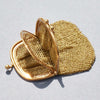 Gold mesh handbag on a light gray background