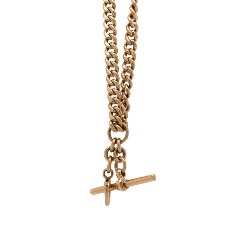 A rose gold antique Albert chain necklace with two lobster clasps and a T-bar and bolt ring.