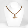 A rose gold antique Albert chain necklace with two lobster clasps and a T-bar and bolt ring.