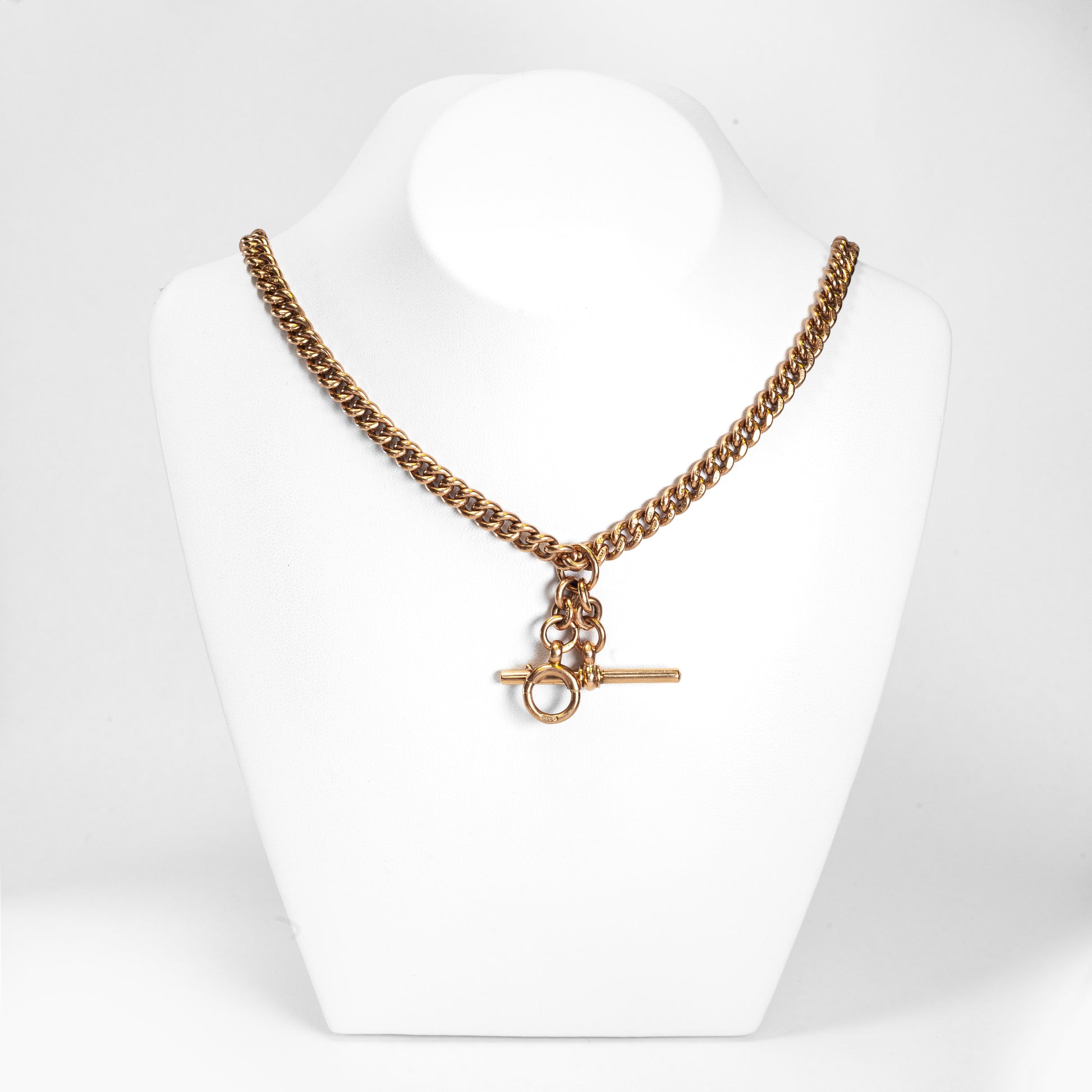 A rose gold antique Albert chain necklace with two lobster clasps and a T-bar and bolt ring.