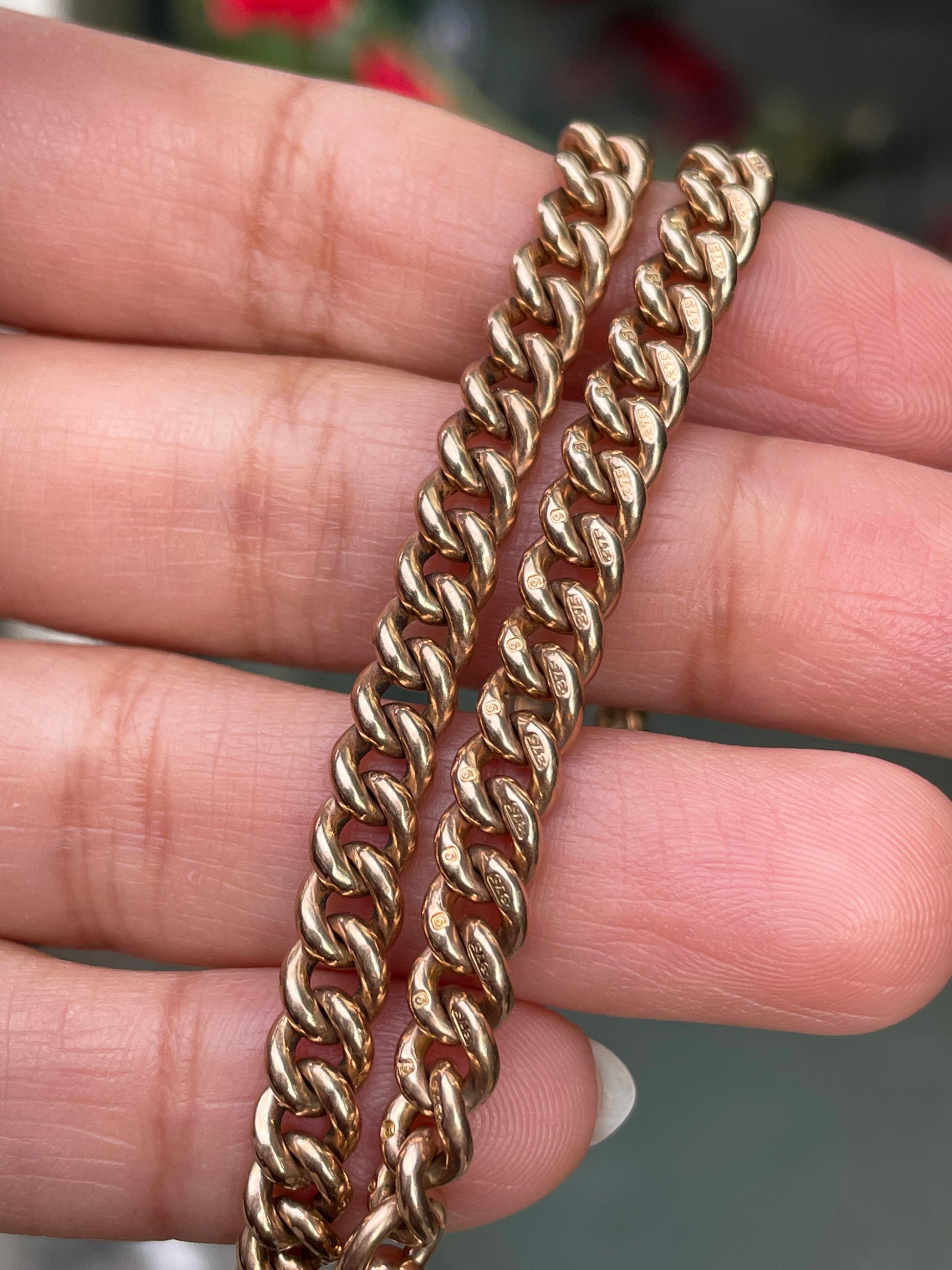 A rose gold antique Albert chain necklace with two lobster clasps and a T-bar and bolt ring.
