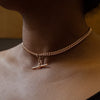 A rose gold antique Albert chain necklace with two lobster clasps and a T-bar and bolt ring on neck