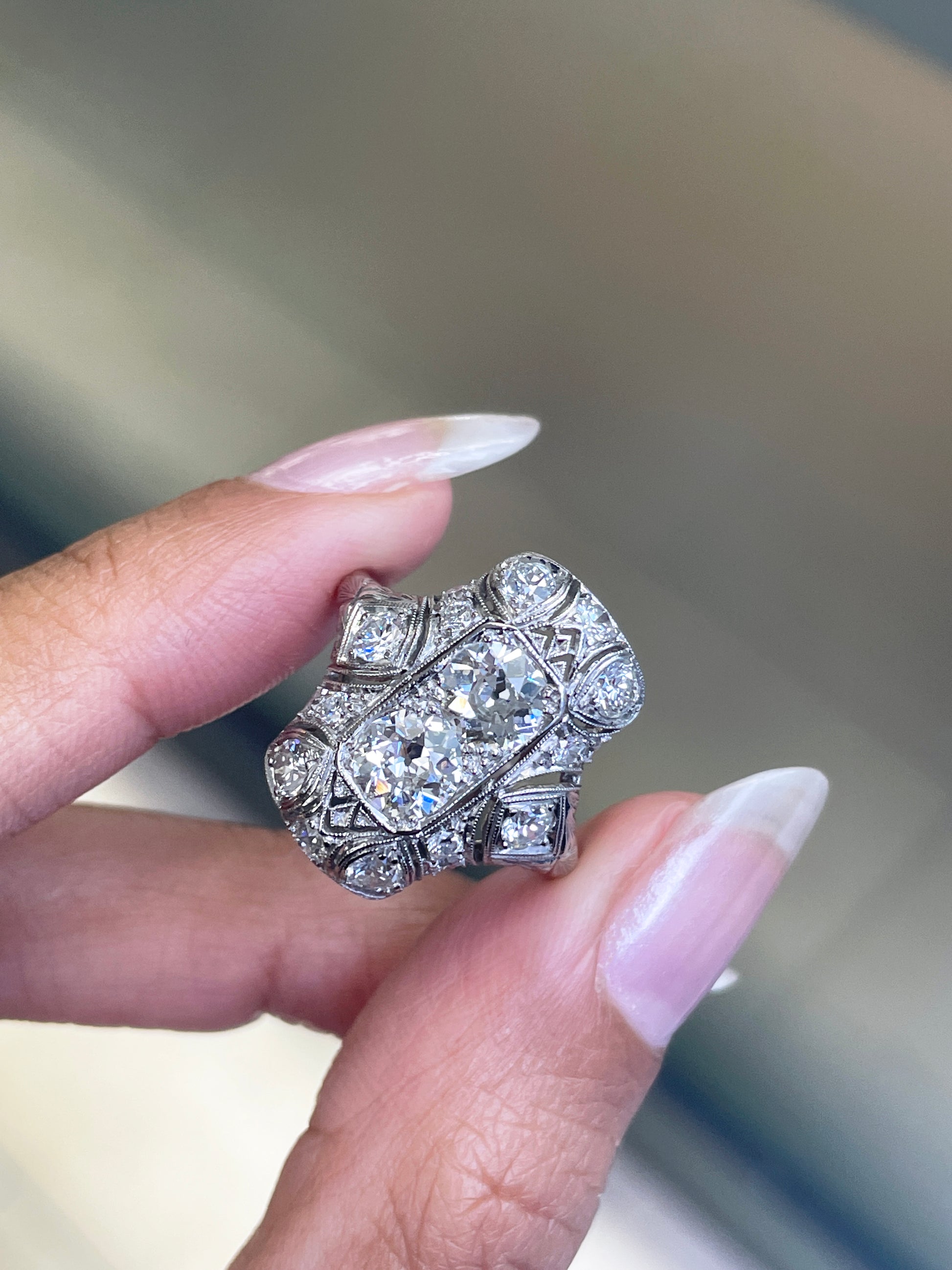 person holding art deco platinum dress ring 