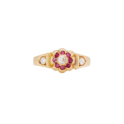 An 1884 Chester-made antique Victorian flower ring with a yellow gold band and old cut diamonds and red rubies