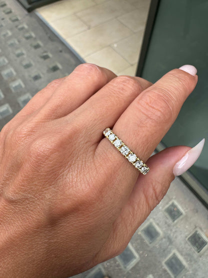Hand wearing a Diamond full eternity stacking band ring in 18ct yellow gold, featuring round brilliant cut diamonds in claw setting,.