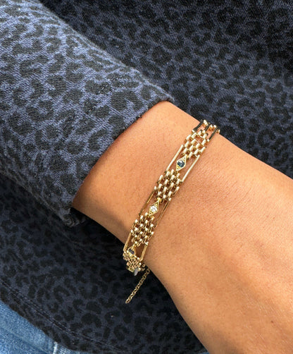 person wearing a Antique Blue Sapphire and Diamond 15 Carat Rose Gold Gate Bracelet