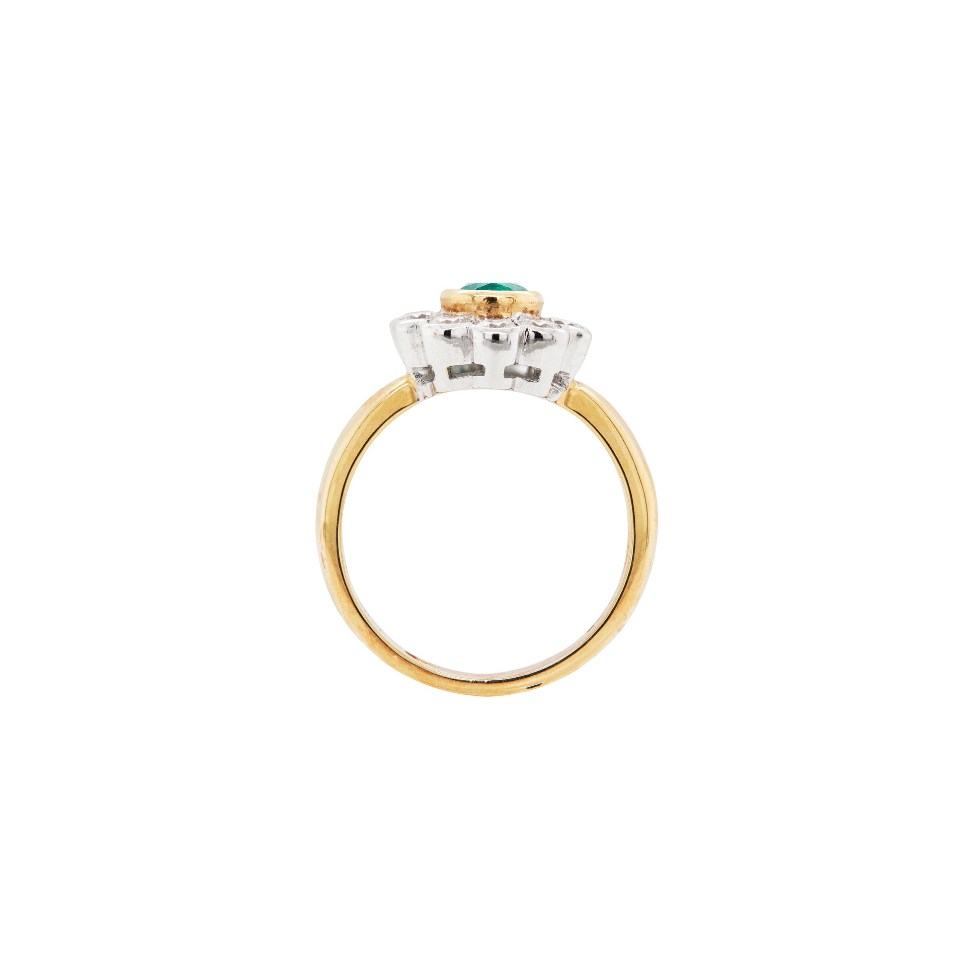 Gold and silver ring with a green gemstone on a white background