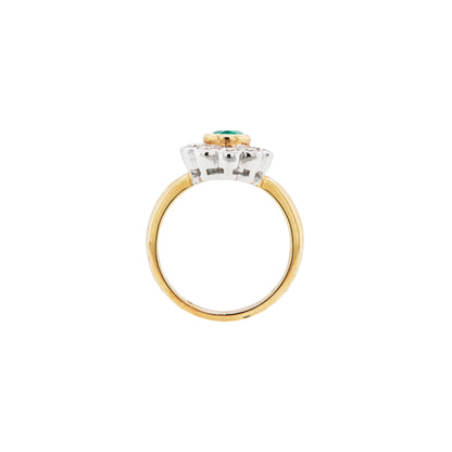 Gold and silver ring with a green gemstone on a white background