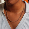 person wearing a gold albert chain with dog clasps 
