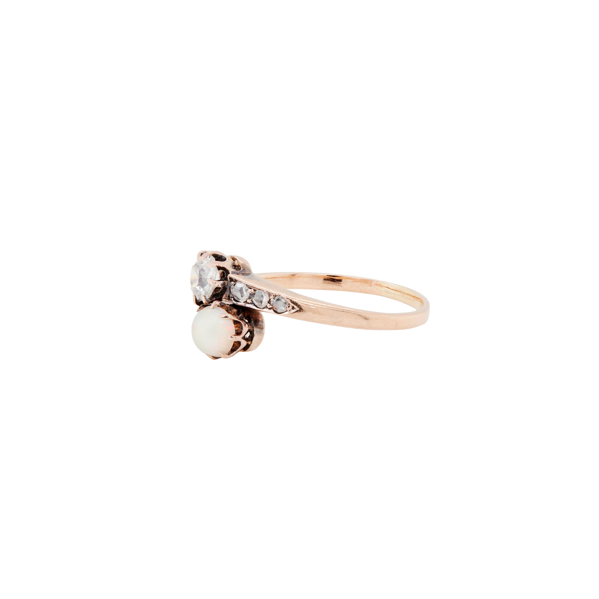 Gold ring with a pearl and small diamonds on a white background