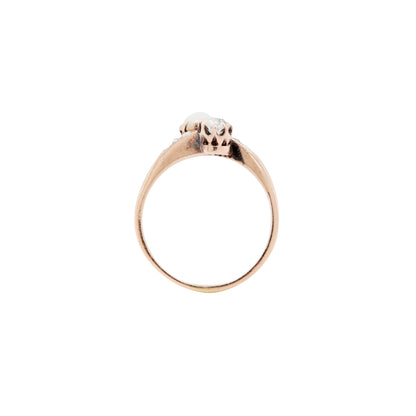 Gold ring with a small diamond on a white background