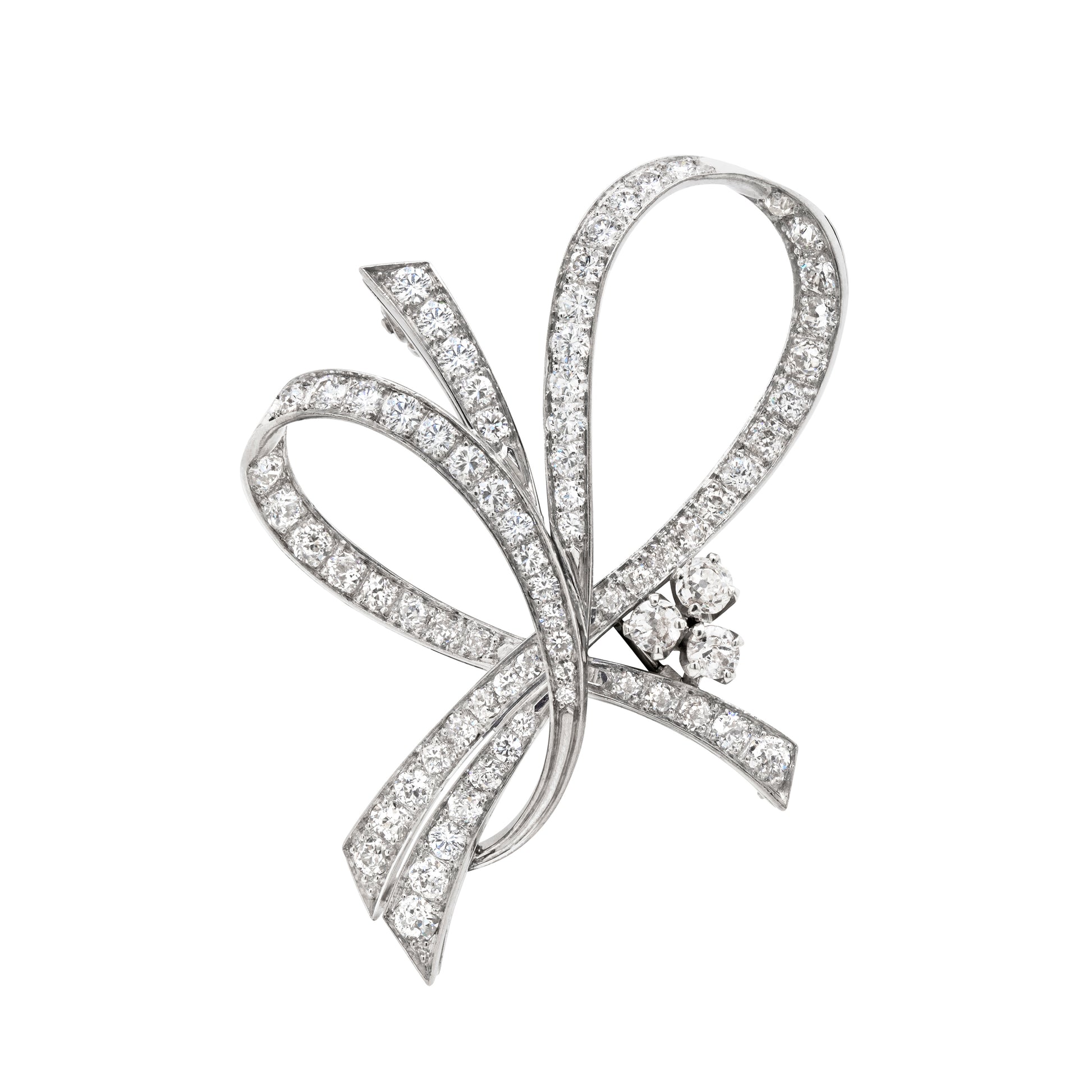 A vintage French diamond platinum ribbon brooch with a twisted ribbon design and old cut diamonds set in open back settings.