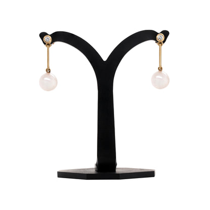 Freshwater Pearl and Diamond 18 Carat Yellow Gold Drop Earrings on a stand