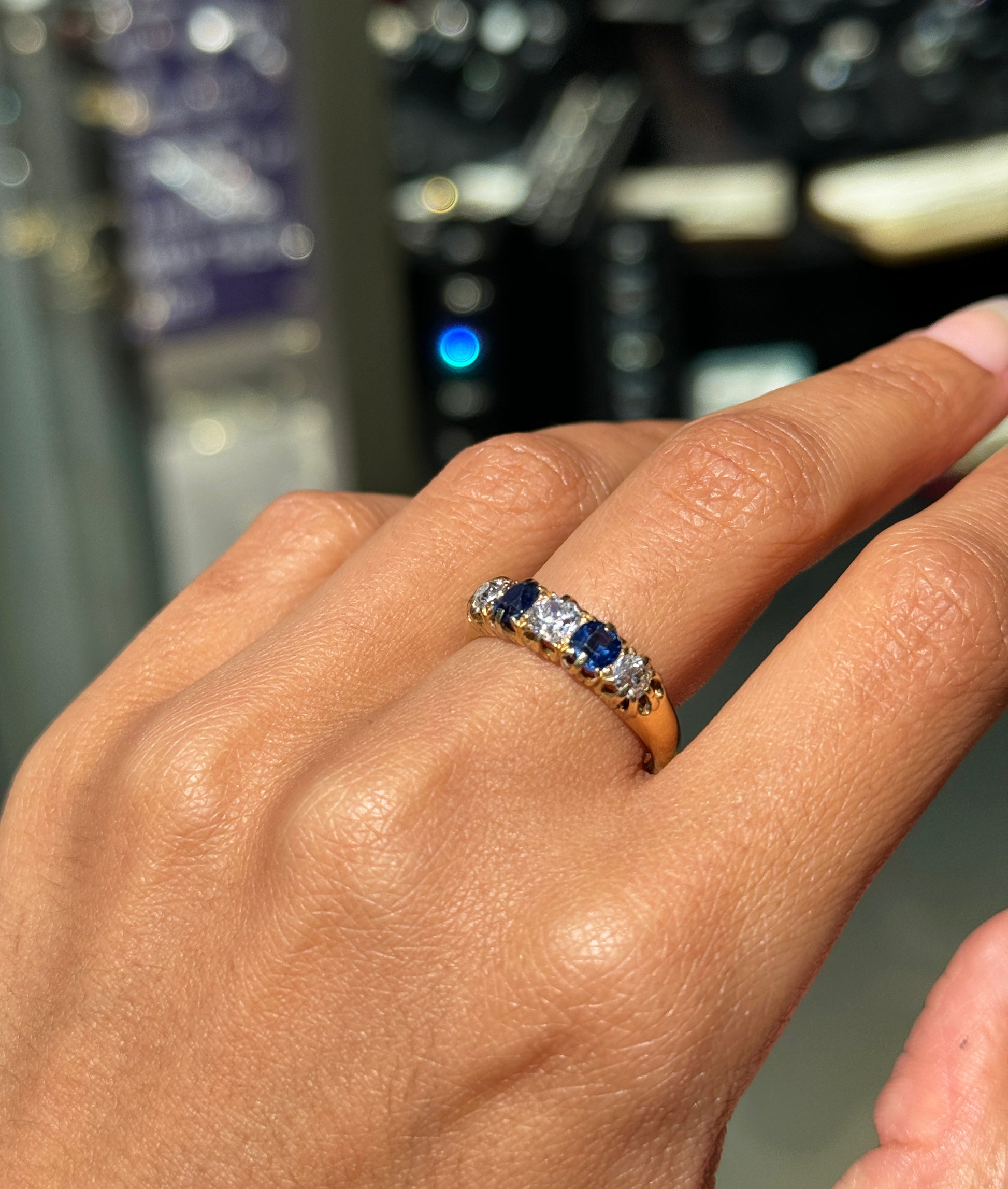 lady wearing a sapphire and diamond victorian ring