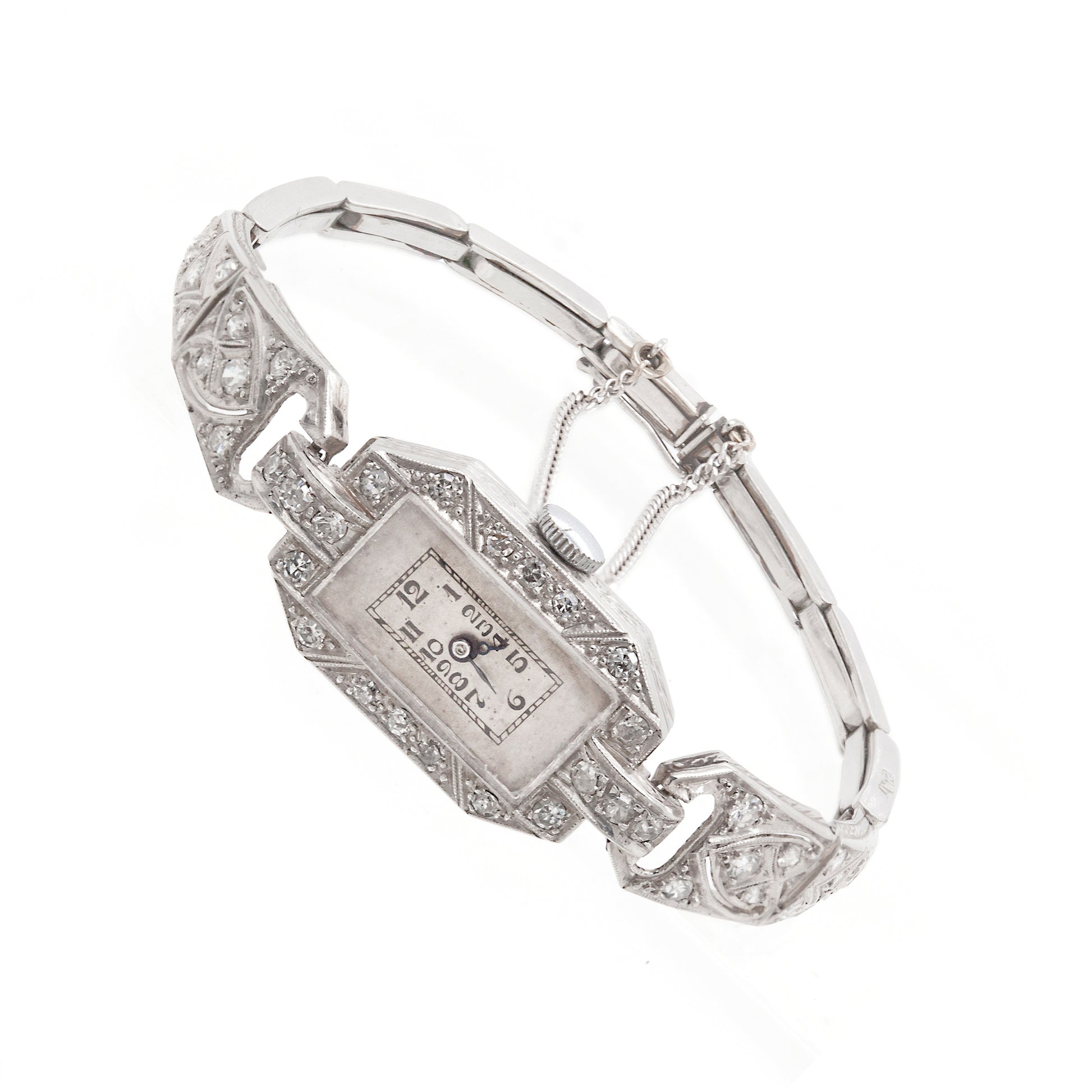 An antique Art Deco cocktail watch with a diamond studded design, featuring a rectangular dial with black Arabic numerals, blued-steel hands, and a geometric patterned bracelet.