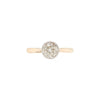 An Art Deco style solitaire diamond ring with a rub-over setting, featuring a millgrain edge on the band, photographed on a white background.