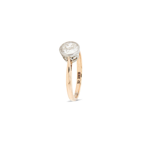 A gorgeous old European cut diamond is rub-over set in platinum, and finished with a millgrain edge to the setting