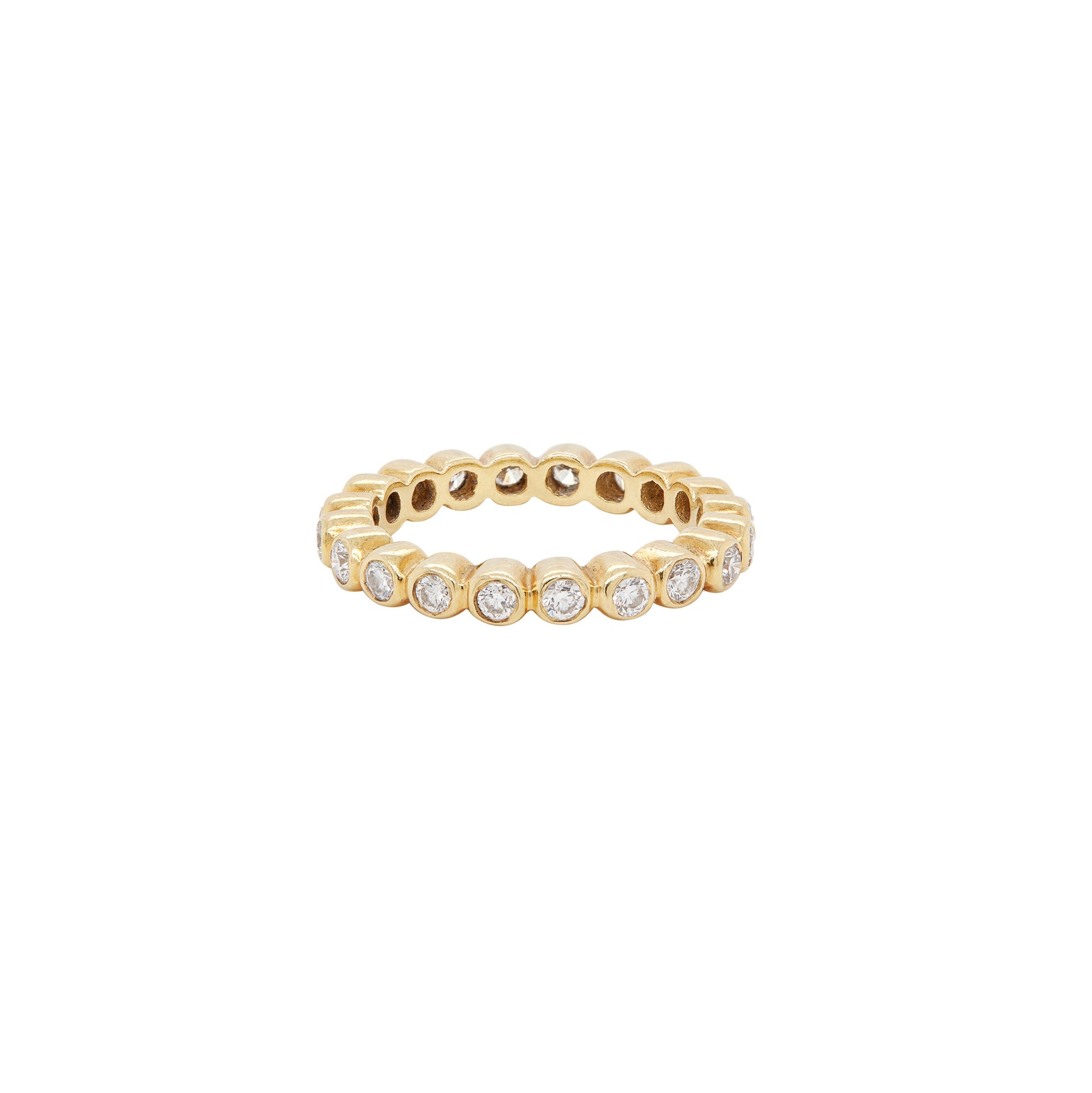 A yellow gold full eternity stacking ring with round brilliant cut diamonds set around its circumference.