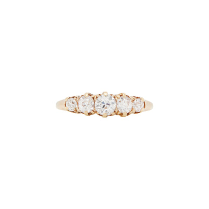 An 18 carat yellow gold ring featuring a five-stone old cut diamond design, with a D-shaped band.