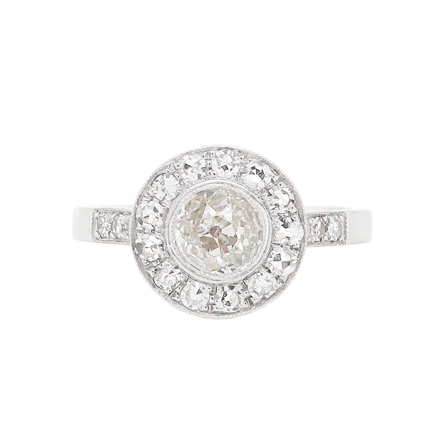 A vintage inspired round old cut diamond 18 carat white gold cluster ring with multiple smaller diamonds set around the central diamond.