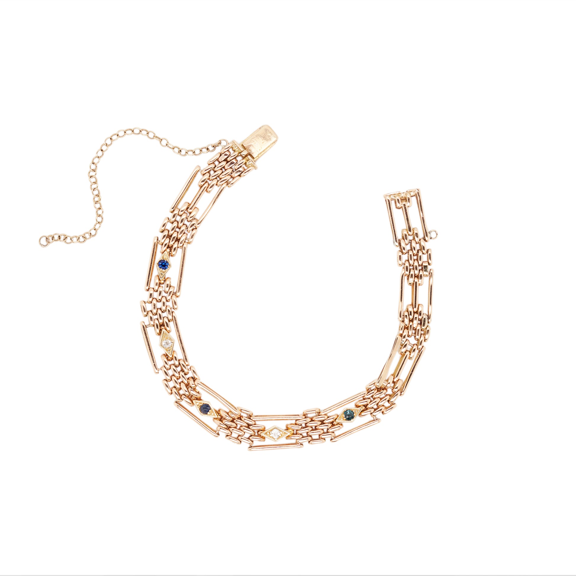 A 15 carat rose gold bracelet featuring a geometric pattern with long bar links and smaller oval links, adorned with three round cut blue sapphires and two old mine cut diamonds.