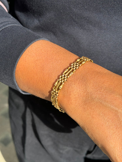lady wearing Antique 15 Carat Yellow Gold Gate Link Bracelet, Circa 1900
