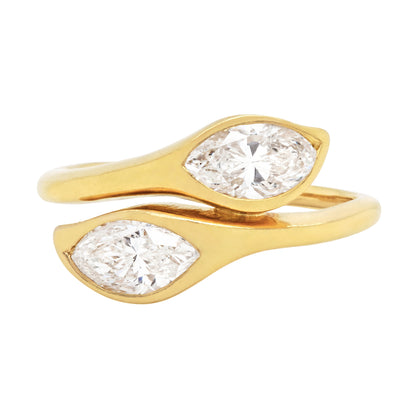 An 18 carat yellow gold ring featuring two marquise shaped diamonds in open back settings.