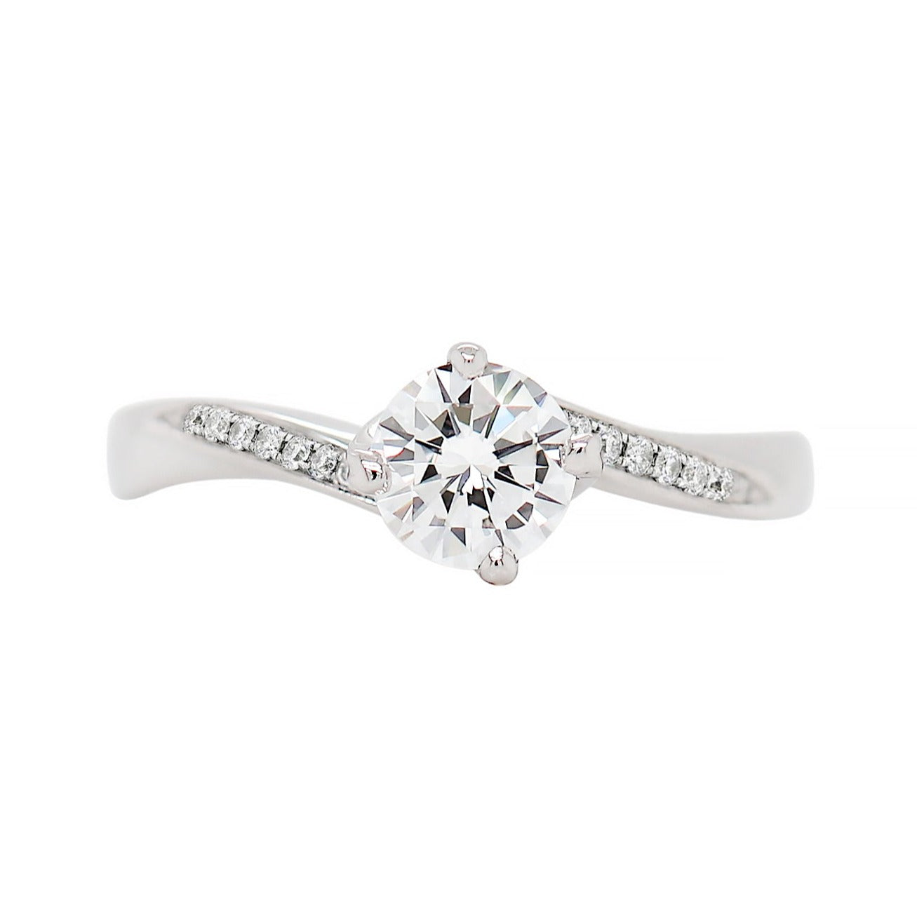 A twist engagement ring with a round brilliant cut diamond centerpiece and smaller round brilliant cut diamonds set in a twisted platinum mount.