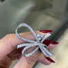 women holding vintage diamond brooch
