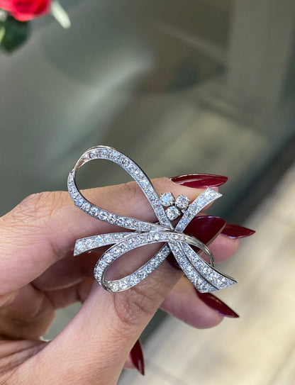 women holding vintage diamond brooch