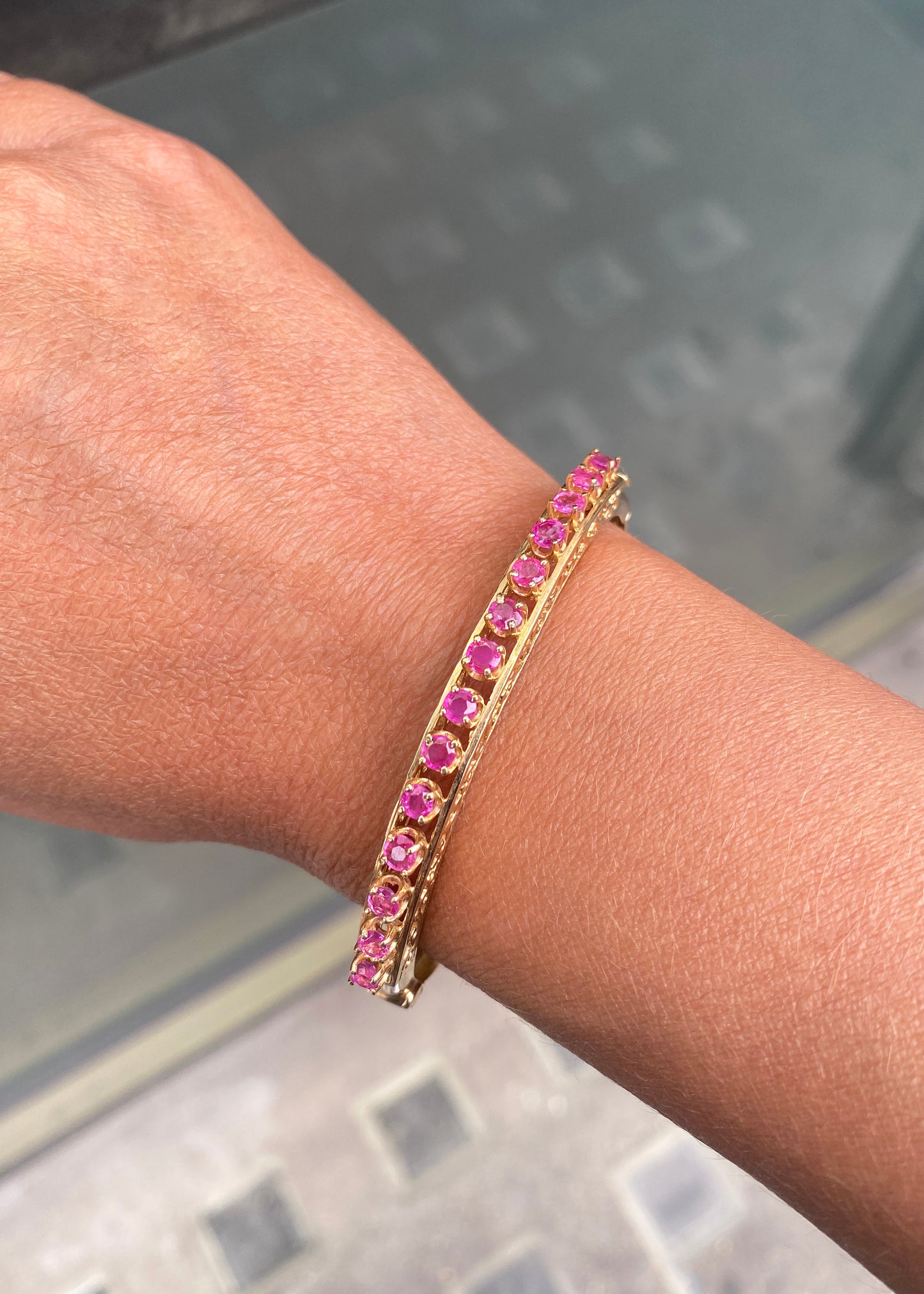 Vintage Ruby and 14 Carat Yellow Gold Open Work Hinged Bangle, circa 1980s