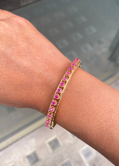 Vintage Ruby and 14 Carat Yellow Gold Open Work Hinged Bangle, circa 1980s