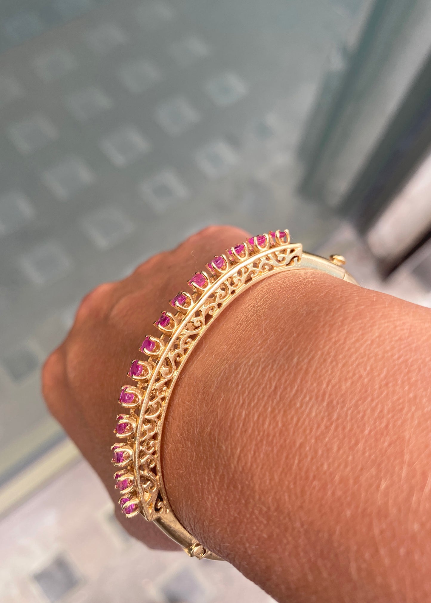 Vintage Ruby and 14 Carat Yellow Gold Open Work Hinged Bangle, circa 1980s