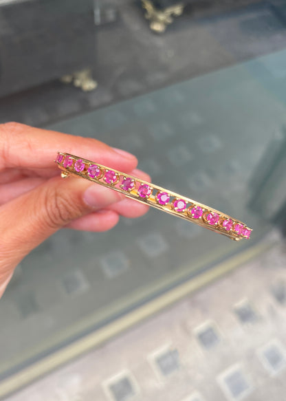 Vintage Ruby and 14 Carat Yellow Gold Open Work Hinged Bangle, circa 1980s