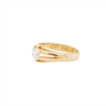 Gold ring with a diamond on a white background