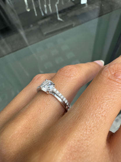 Close-up of a hand wearing a diamond ring with a blurred background