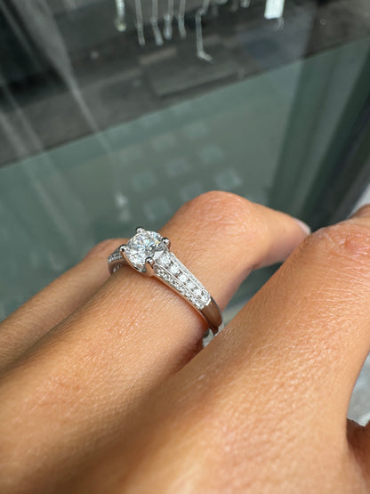 Close-up of a hand wearing a diamond ring with a blurred background