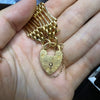 close up of heart shaped padlock om 18 carat bracelet
