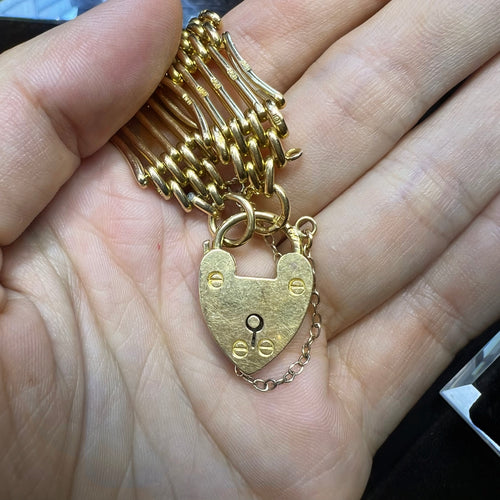 close up of heart shaped padlock om 18 carat bracelet
